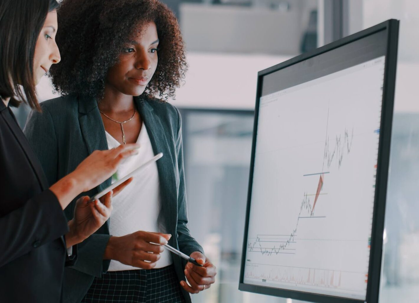 businesswomen using an interactive whiteboard