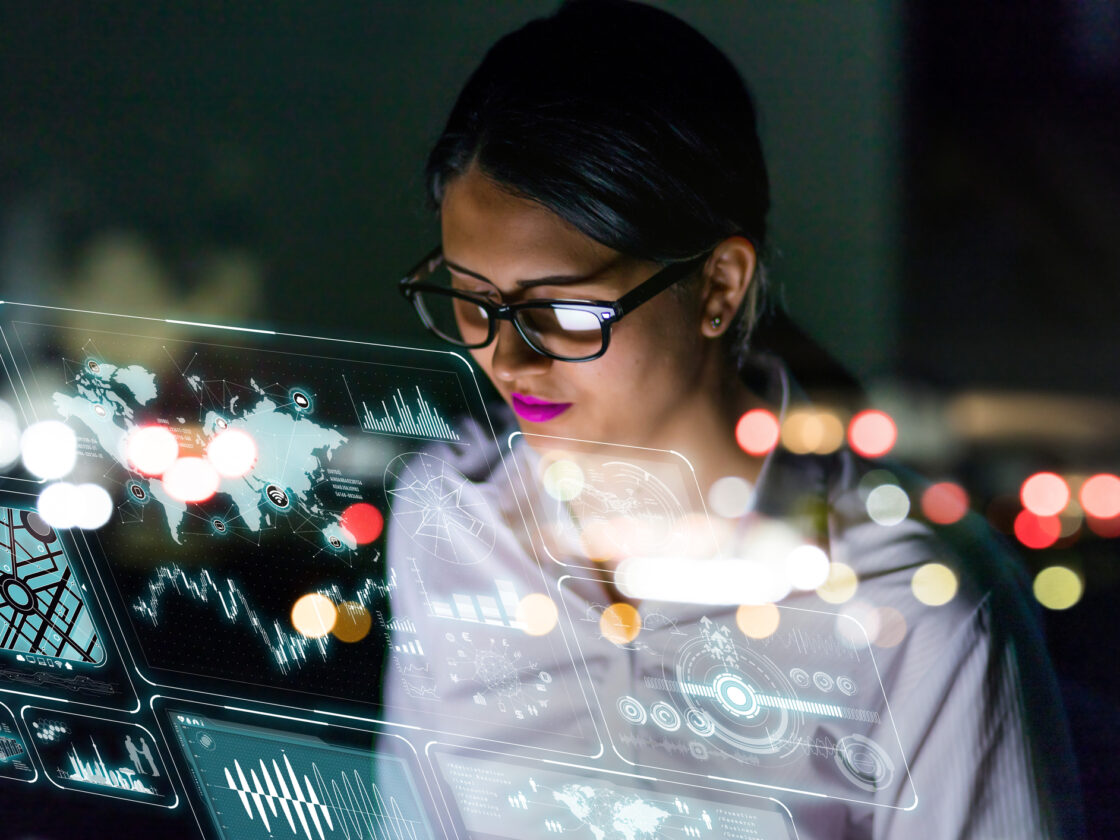 engineer looking at various information in screen of futuristic interface