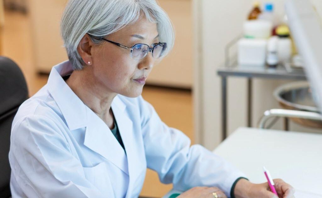 Doctor at a desk looking at a computer